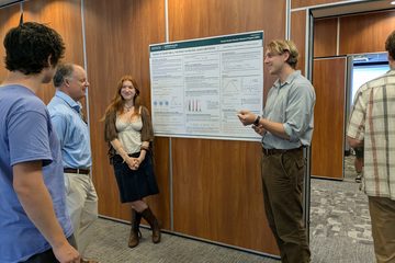 Adam Blyberg and Marta Insolia presenting their summer research poster