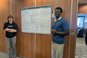 Finlay Savoir and Michael Gyampo with the lattice gauge theories poster